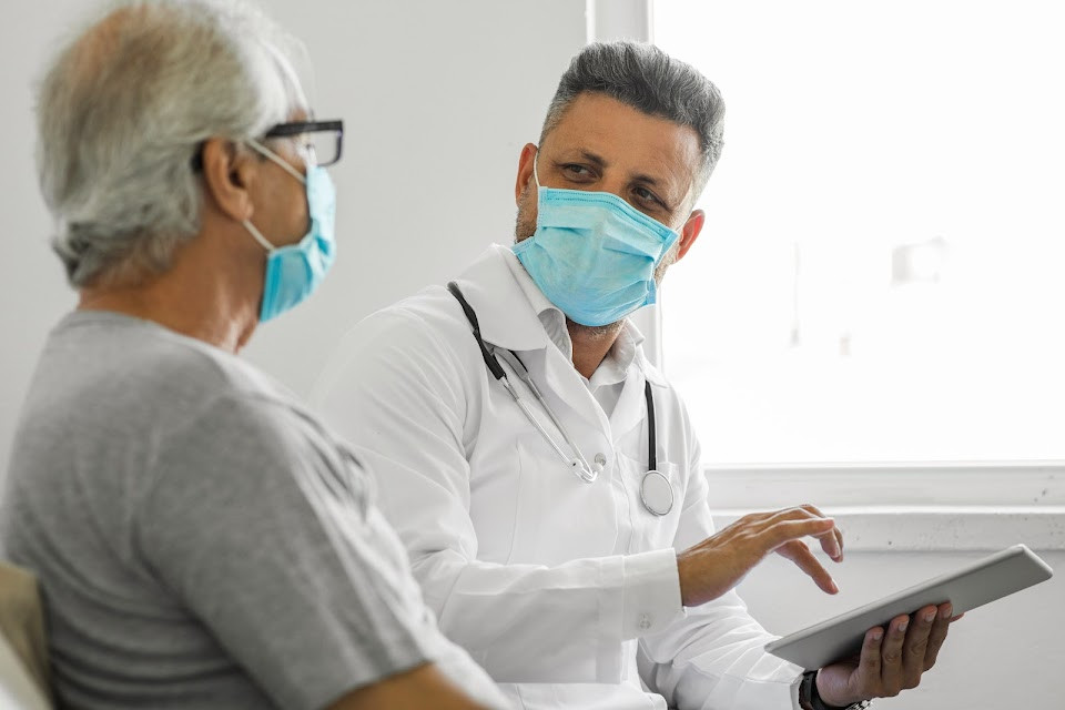 Doctor assisting patient.