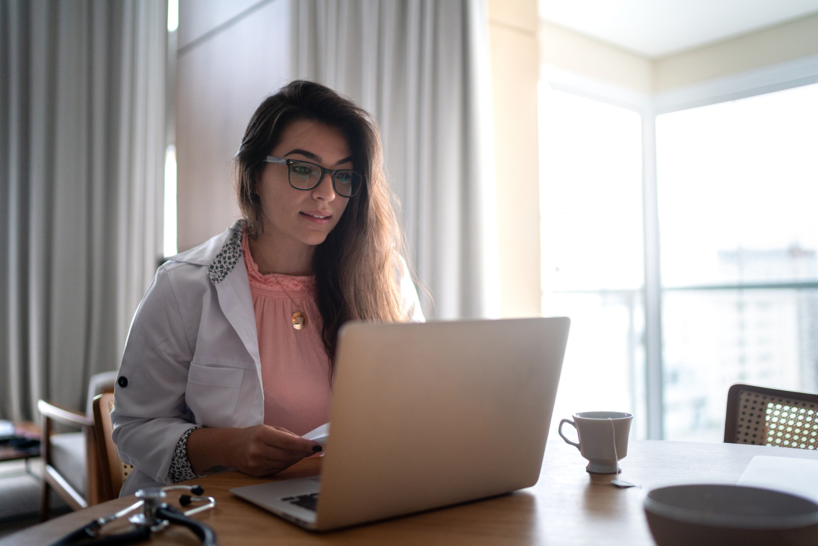 Health professional participating in online webinar.