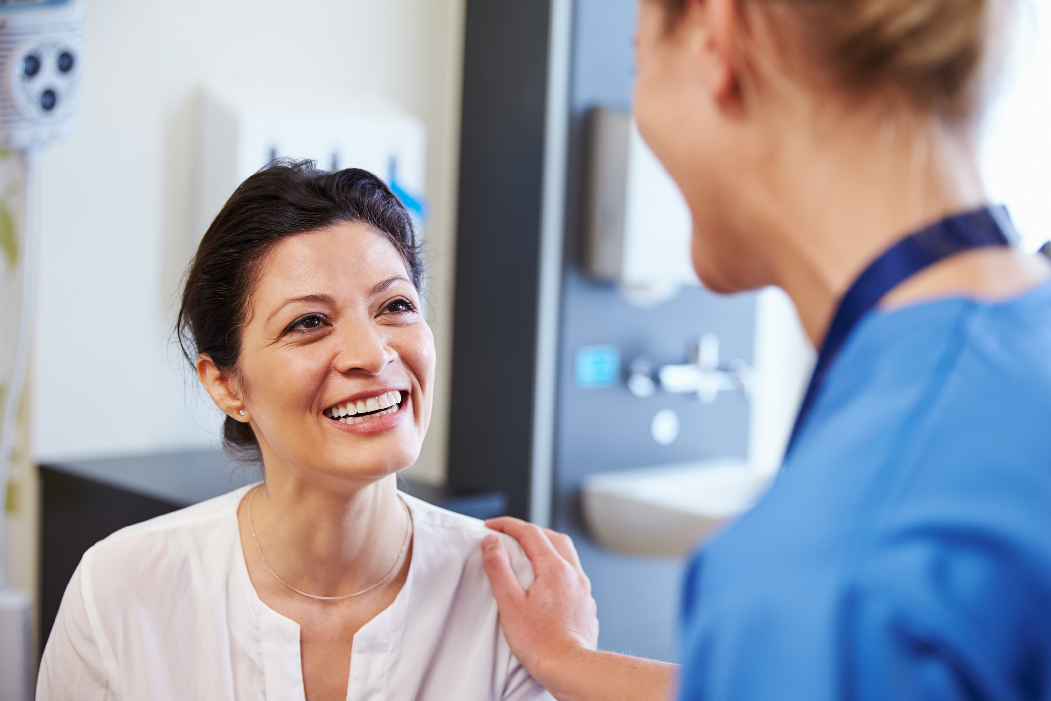 Practice nurse speaking with a female patient