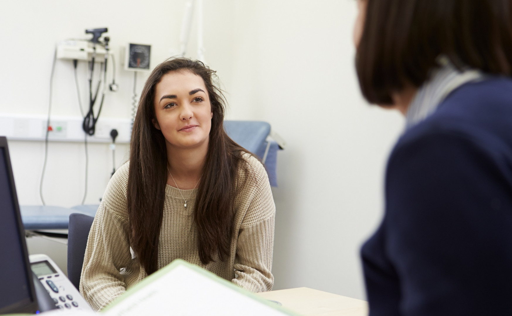 GP talking with female patient.