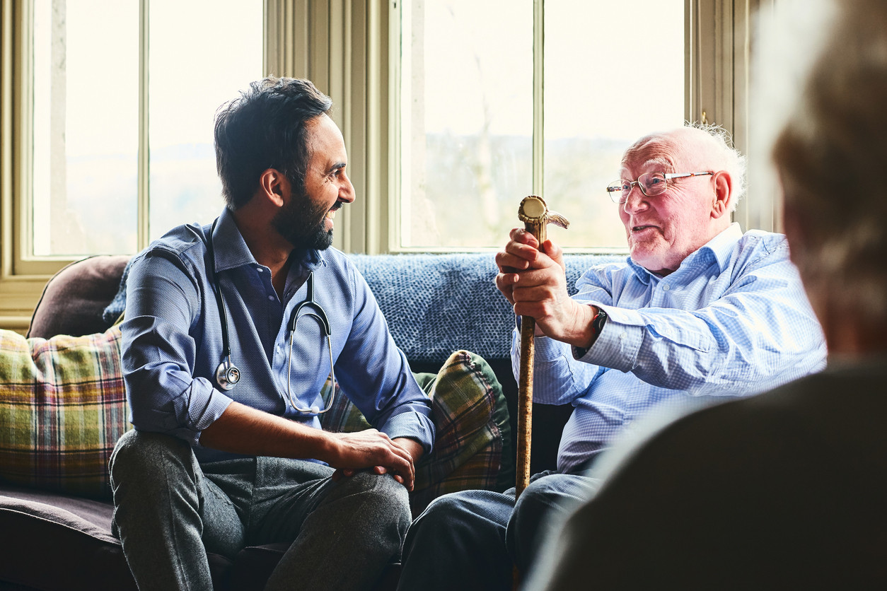 Male doctor and patient talking and laughing.